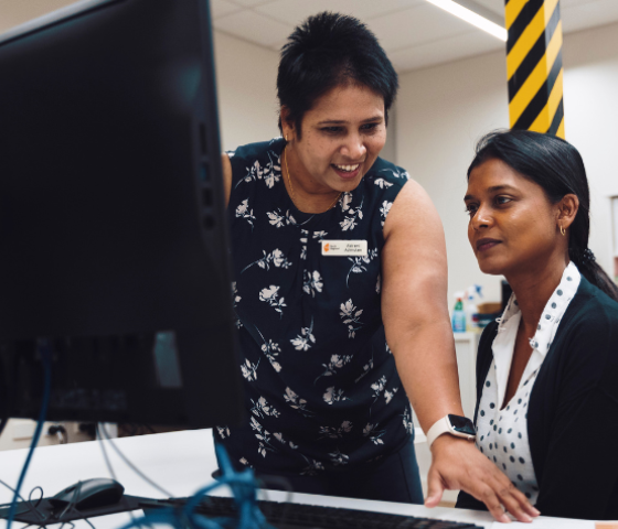 lecturer and student working at a computer 