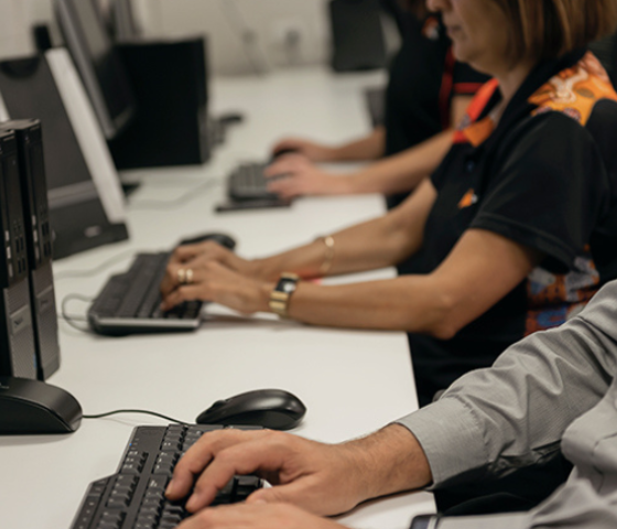 students typing at desks 